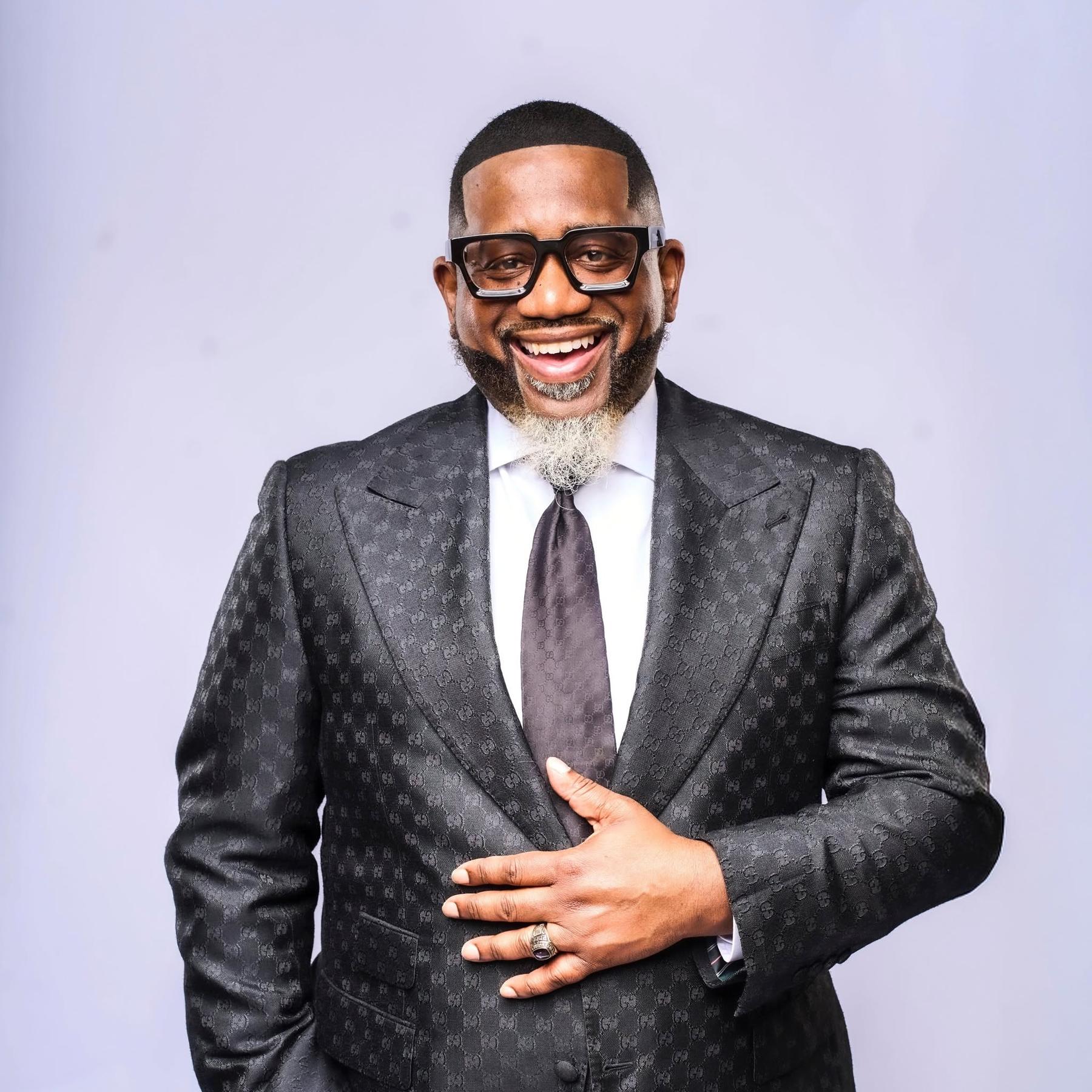 Bishop Robert Nichols Jr. smiling in a suit